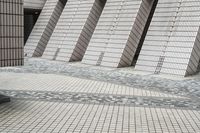 a small courtyard with bricks around the corner and a bench under it to sit on