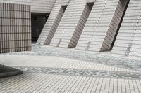 a small courtyard with bricks around the corner and a bench under it to sit on