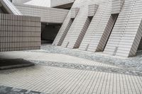 a small courtyard with bricks around the corner and a bench under it to sit on