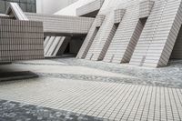 a small courtyard with bricks around the corner and a bench under it to sit on