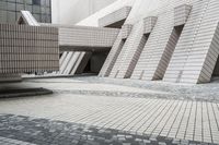 a small courtyard with bricks around the corner and a bench under it to sit on