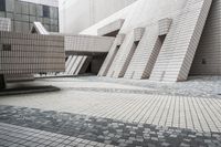 a small courtyard with bricks around the corner and a bench under it to sit on