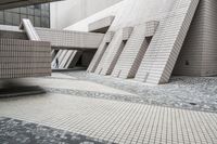 a small courtyard with bricks around the corner and a bench under it to sit on