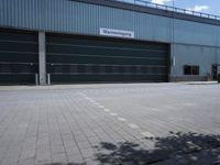 an empty parking lot has a building and sign on the doors that say warengsping