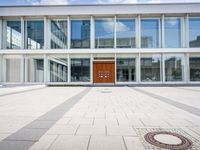 this is an image of a building entrance with an empty street below it and a man walking across a path