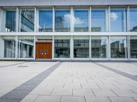 this is an image of a building entrance with an empty street below it and a man walking across a path