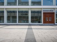 this is an image of a building entrance with an empty street below it and a man walking across a path