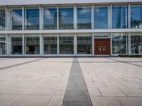 this is an image of a building entrance with an empty street below it and a man walking across a path