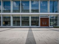 this is an image of a building entrance with an empty street below it and a man walking across a path