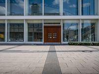 this is an image of a building entrance with an empty street below it and a man walking across a path