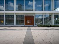 this is an image of a building entrance with an empty street below it and a man walking across a path