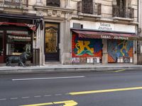 a building with a large window that reads janus journal and a street with traffic