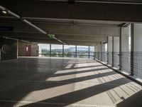 a person walking around an empty parking lot by some large windows that have some blinds