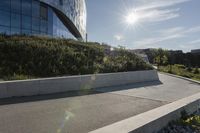 a view of an outside area of an office building with large windows and a circular driveway