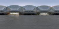 this image is a panoramic shot of architecture on a cloudy day taken from a camera