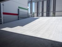 an empty garage with the sun shines on it's back doors and flooring