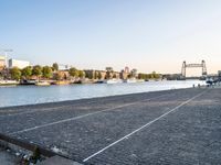 a body of water with a tennis court next to it and many boats in the water