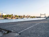 a body of water with a tennis court next to it and many boats in the water