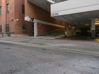 a building is next to an empty parking garage with the roof extended in front of it