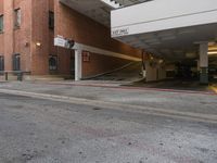 a building is next to an empty parking garage with the roof extended in front of it