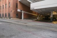 a building is next to an empty parking garage with the roof extended in front of it