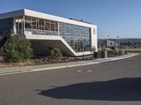 the large building has a staircase leading up to it's upper level, and a ramp in between it