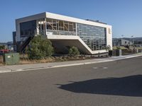 the large building has a staircase leading up to it's upper level, and a ramp in between it