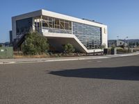 the large building has a staircase leading up to it's upper level, and a ramp in between it