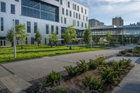 a walkway between two tall buildings with plants growing on the sides of them in front of some grass