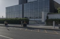 the empty side of a building with a parking lot below it and a sign that reads no parking on it