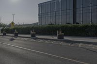 the empty side of a building with a parking lot below it and a sign that reads no parking on it