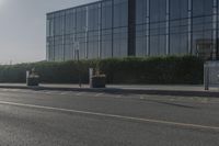 the empty side of a building with a parking lot below it and a sign that reads no parking on it