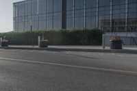 the empty side of a building with a parking lot below it and a sign that reads no parking on it