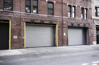 an old building is covered in graffiti and graffiti paper on the side of it, with a fire hydrant, street signs, trash cans and a fire hydrant, some windows and a curb, and a black trash can all