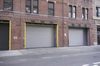 an old building is covered in graffiti and graffiti paper on the side of it, with a fire hydrant, street signs, trash cans and a fire hydrant, some windows and a curb, and a black trash can all