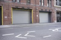 an old building is covered in graffiti and graffiti paper on the side of it, with a fire hydrant, street signs, trash cans and a fire hydrant, some windows and a curb, and a black trash can all
