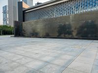 a sidewalk with the letters c painted on it and buildings in the background with a sky line