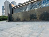 a sidewalk with the letters c painted on it and buildings in the background with a sky line