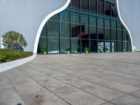 the outside of a building with glass walls and a red fire hydrant sitting next to it