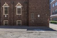 an old brick building with several windows on it's side that looks like the town of the other side