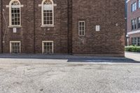 an old brick building with several windows on it's side that looks like the town of the other side