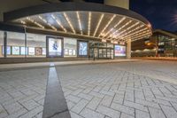 the large entrance to an outdoor concert venue with large windows and some signs on it