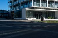 a building on a street corner with some people and cars around it, looking at the building