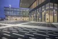 the street is filled with multiple empty areas to be seen through the glass door of the building