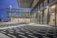 the street is filled with multiple empty areas to be seen through the glass door of the building