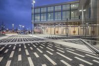 the street is filled with multiple empty areas to be seen through the glass door of the building