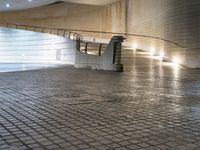 an escalator made out of stone blocks under a light that shines on top of the ground