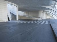 this is an outdoor space with concrete walls and stairs leading to a parking garage area