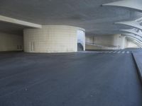 this is an outdoor space with concrete walls and stairs leading to a parking garage area
