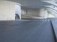 this is an outdoor space with concrete walls and stairs leading to a parking garage area